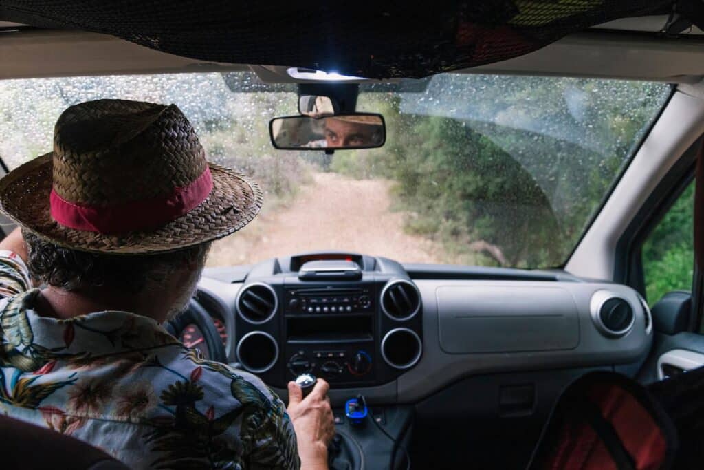 4WD Tours Queensland – Our Top 5 Destinations 14 Man in a wicker hat driving down a dirt road | image for the Basics of Off Roading: How to Get Started blog.