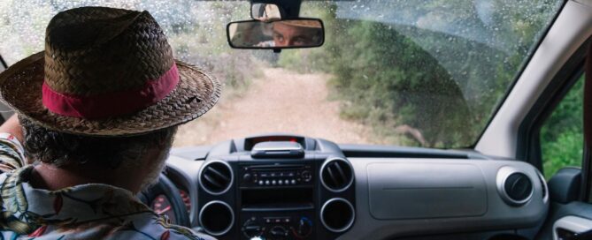 Basics of Off Roading: How to Get Started 12 Man in a wicker hat driving down a dirt road | image for the Basics of Off Roading: How to Get Started blog.